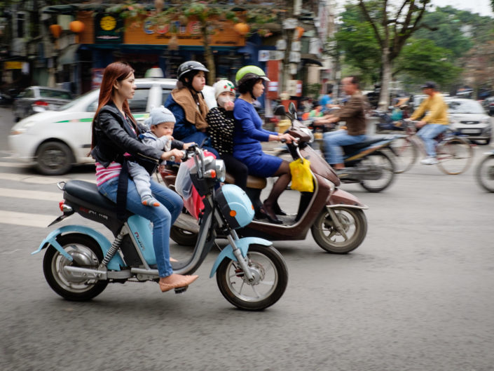 Vietnamese woman and baby on moped